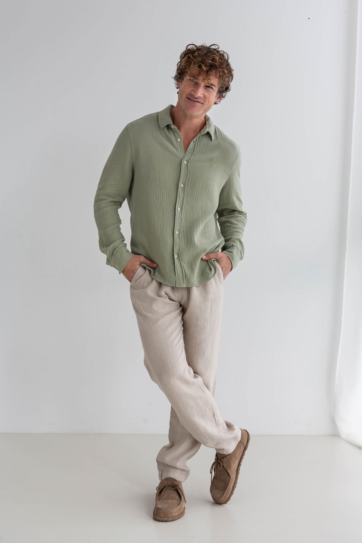 Light green muslin shirt men light pants full body view front