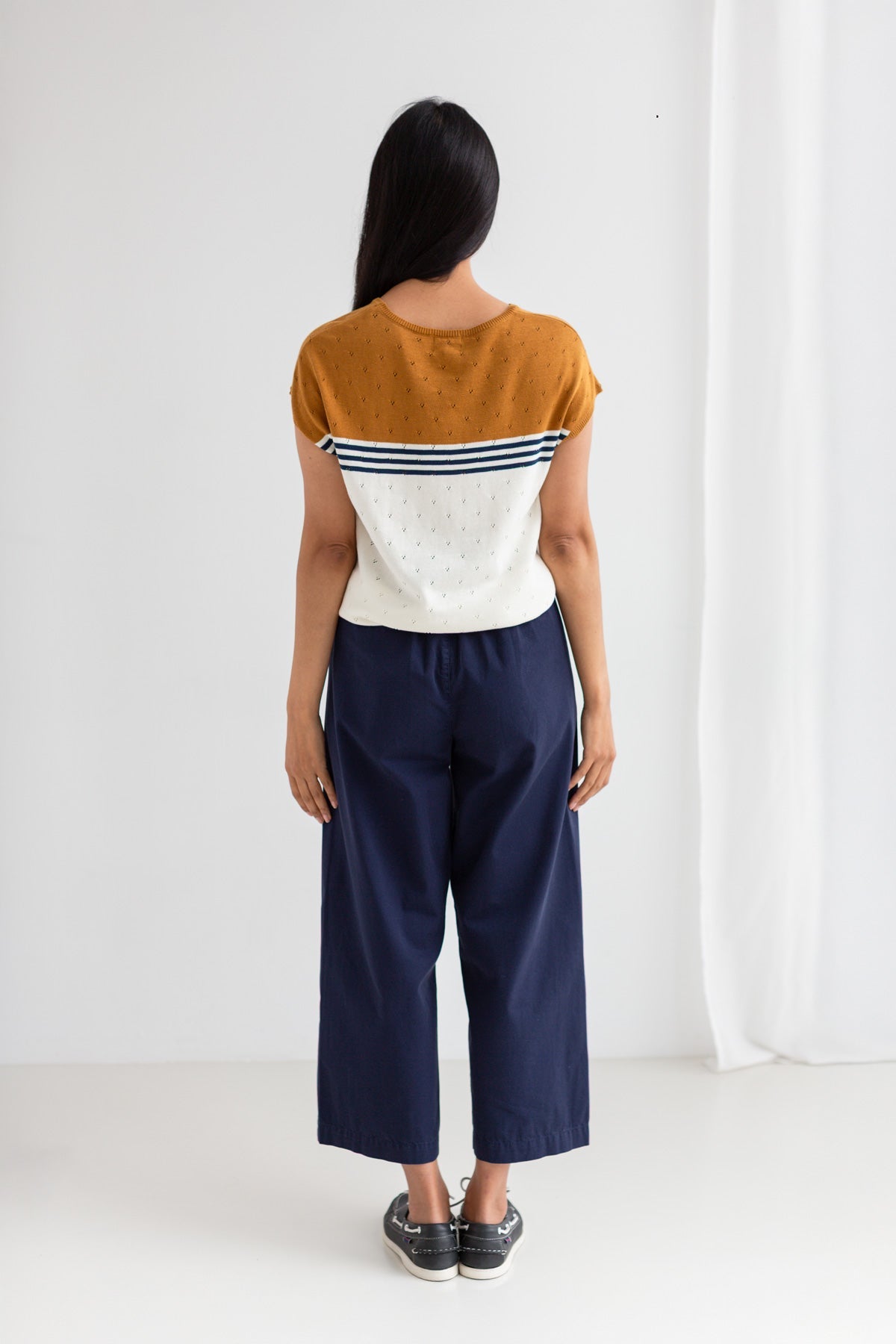 Ecru mustard knit top women navy pants full body view back