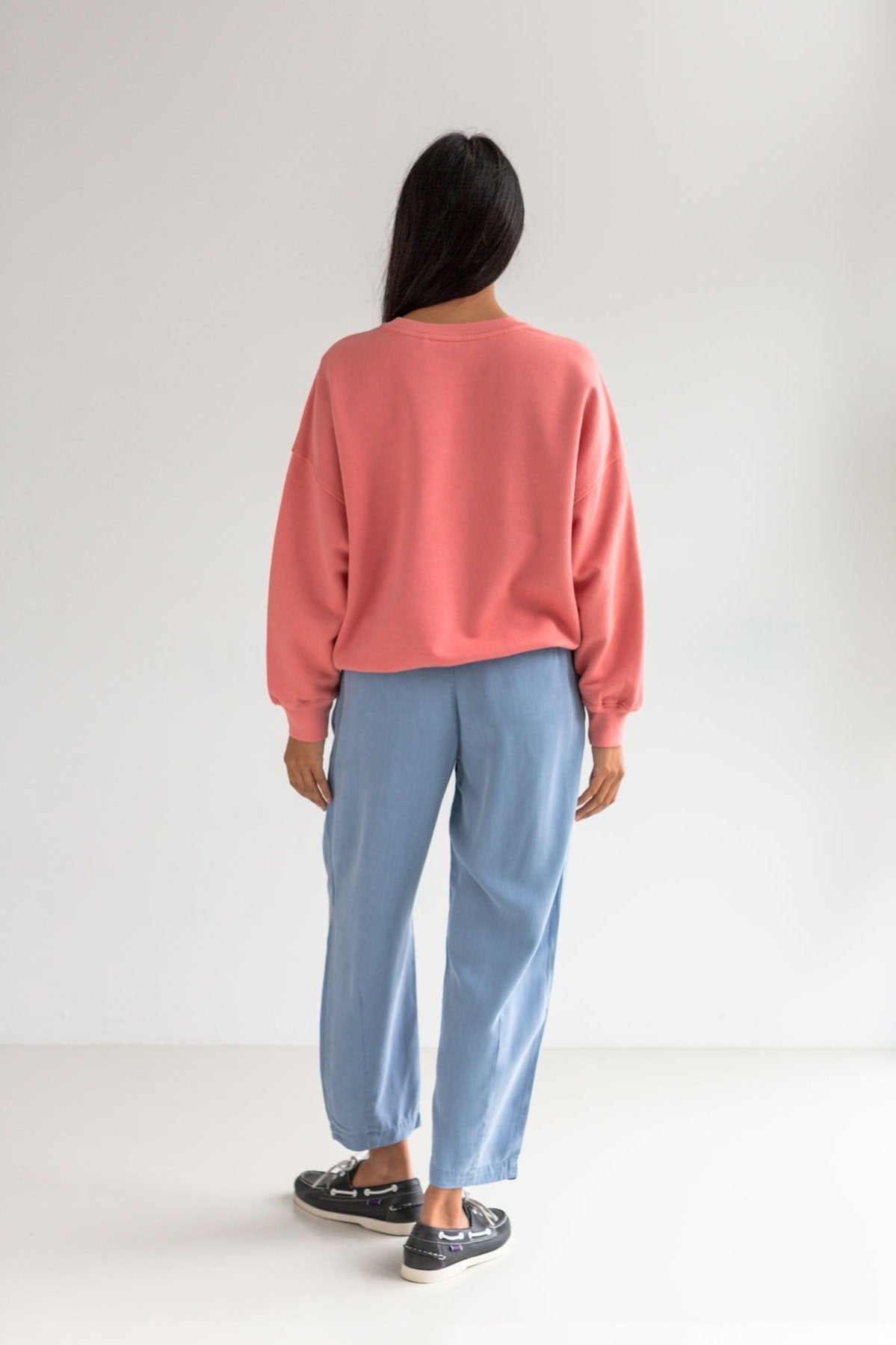 Pink American fleece sweatshirt women light blue pants full body view back