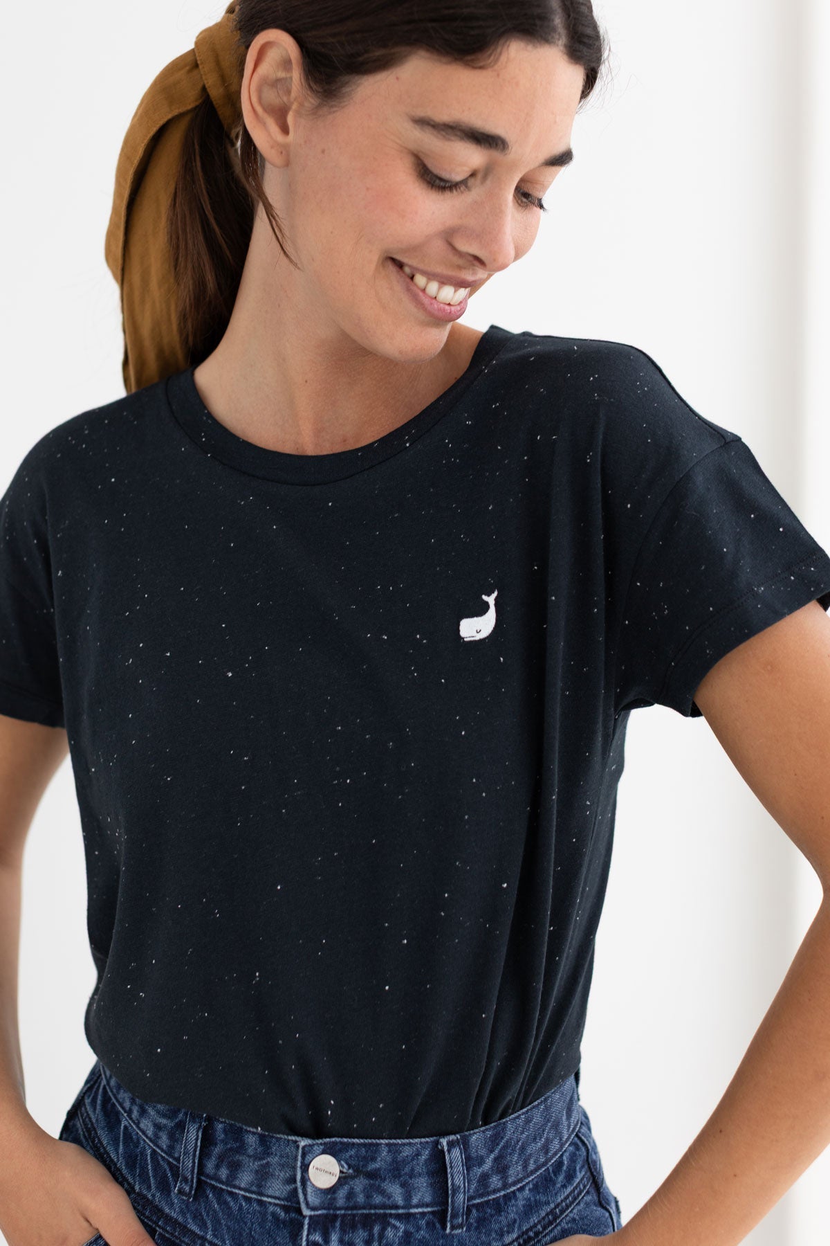 embroidered whale on black organic cotton tee