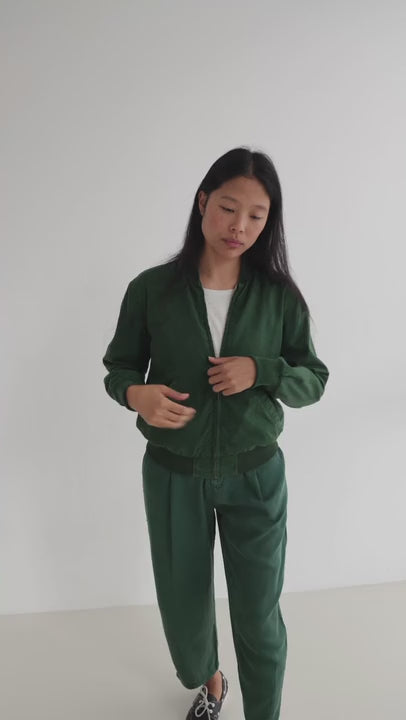 Dark green bomber jacket women green pants full body view
